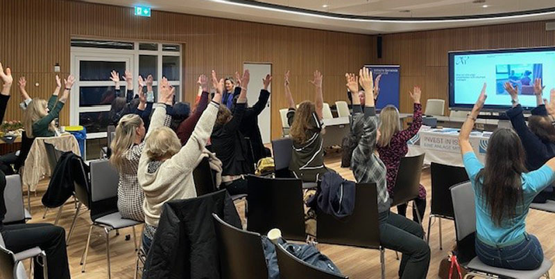 At the Jewish Community Centre in Frankfurt, Shai leads participants in therapeutic yoga stretches, guiding them through exercises using their chairs