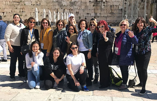 KOL-Mar-2026-Farewell-Laura-Orzy-Delegation-Photo The International Women's Division delegation at the Kotel with Laura (center) in 2019.
