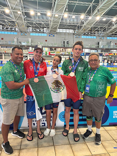 Team Mexico coaches celebrate poolside with swimmers Alberto Tawil, Francis Ovseyevitz, and Gabriel Feldman at the 22nd Maccabiah Games.